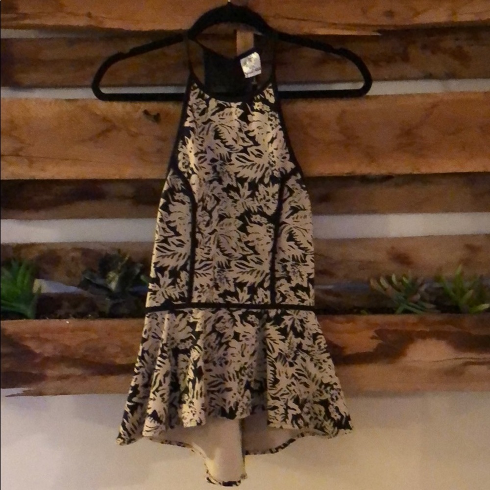 Peplum top with black mesh detailing in the back
